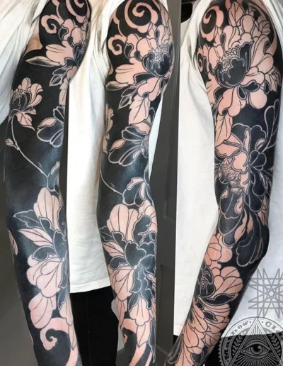 Black Peonie sleeve tattoo by Mathew